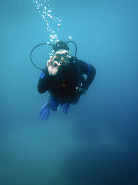 istock Scuba diver underwater showing OK signal 694982858
