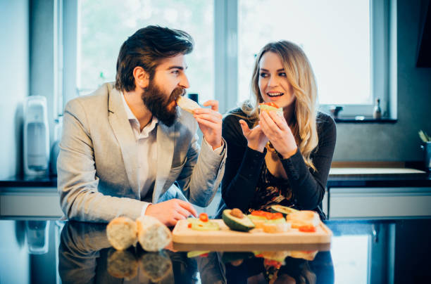 istock Young beautiful couple having diner in the kitchen 694983060