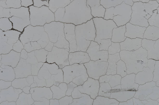 istock Cracked old gray cement concrete stone wall vintage dirty texture background 694997978