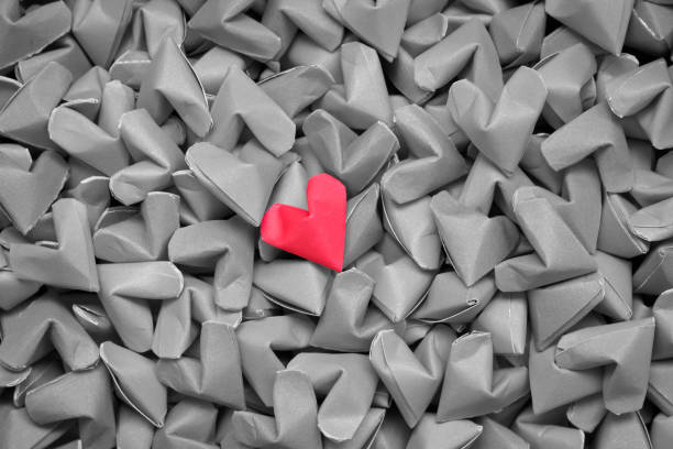 istock single red heart on many black and white hearts 695003910