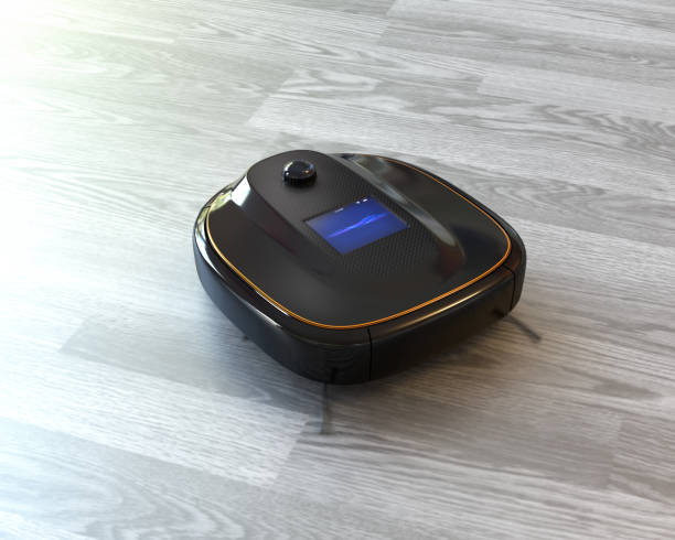 istock Black robotic vacuum cleaner on laminate flooring 695007078