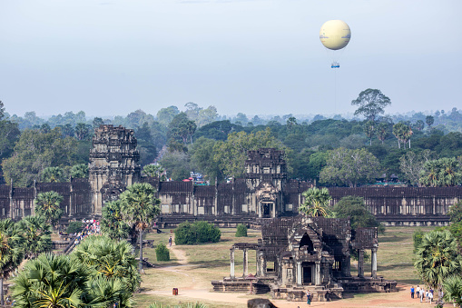 A hot air balloon floats over the Angkor Wat Gateway, as seen from the highest level of the temple of Angkor Wat.