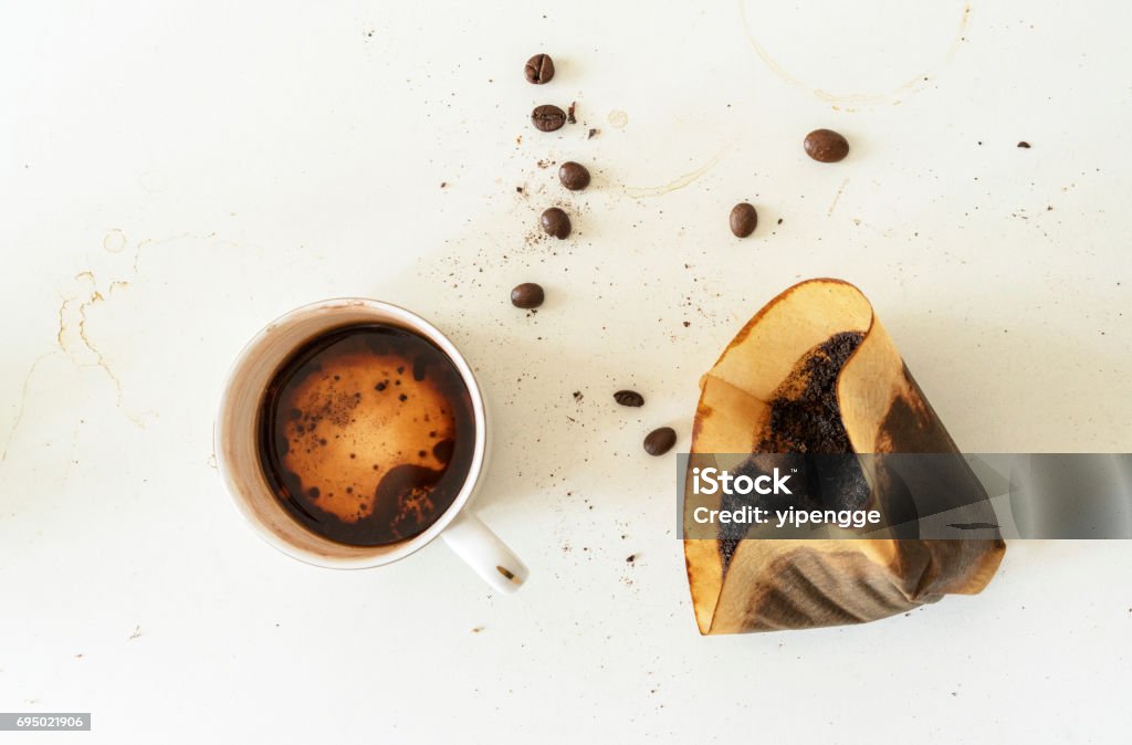 coffee beans, used filter paper and residual in coffee cup Coffee - Drink Stock Photo