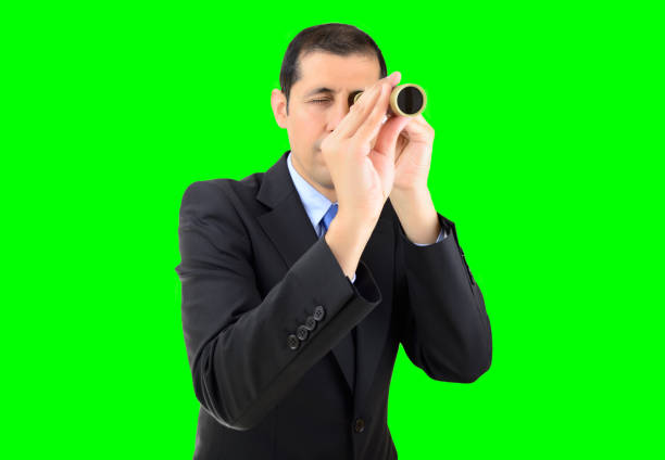 searching a new job with chrome key businessman entrepreneur looking through spyglass searching business and employment opportunities isolated cutout on green background with chroma key monocular vision stock pictures, royalty-free photos & images