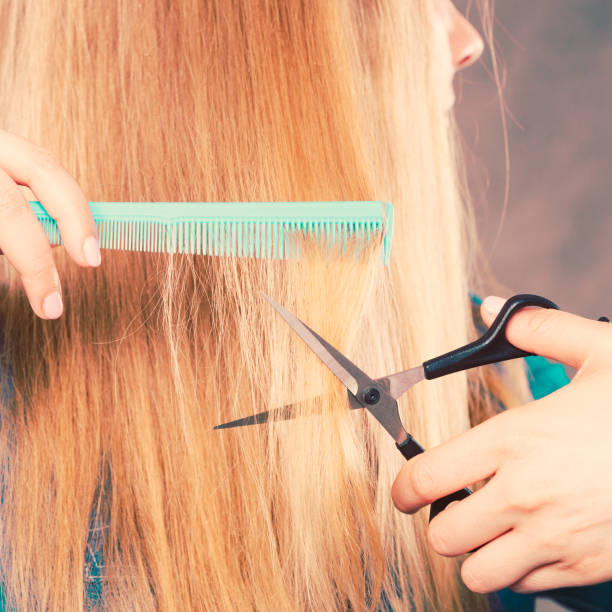 istock Woman cutting down smoothy hair. 695037538
