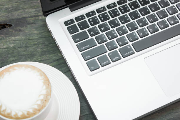 istock Coffee cup and laptop business 695045254