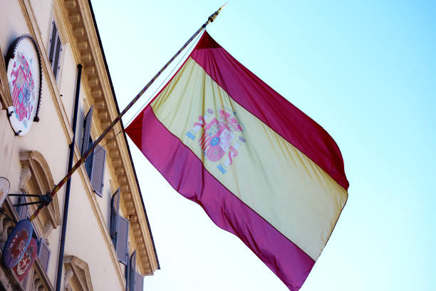istock Spanish flag waving on spanish embassy in Rome Italy 695048524