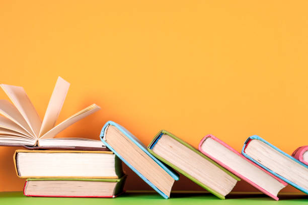 istock Open book, hardback books on bright colorful background. 695058522