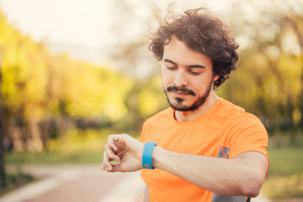 istock Sportsman looking at his smart watch 695058622