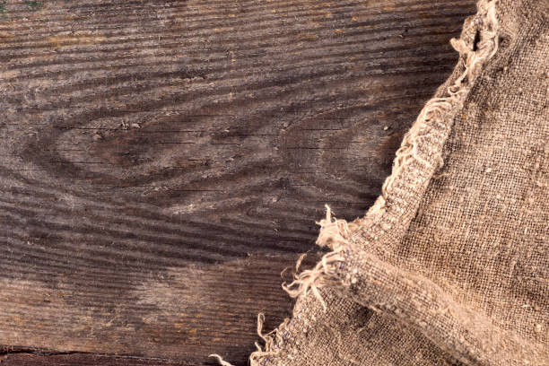 istock burlap hessian sacking on wooden background 695059824