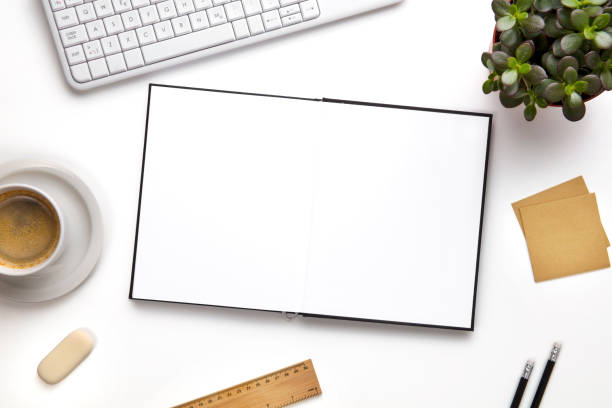 istock Open Blank Diary Surrounded With Office Supplies And Keyboard 695062356