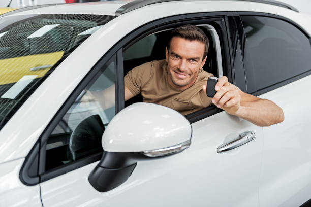 istock Joyful male keeping car key 695065338