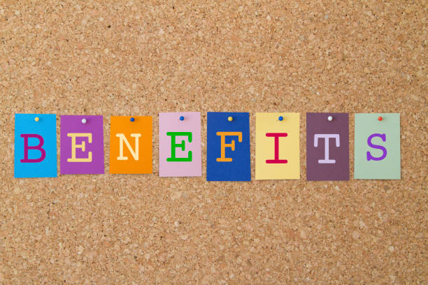 BENEFITS word written on colorful sticky notes pinned on cork board.