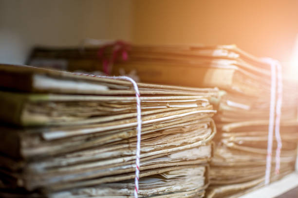 Paper files in a folder is a old documents or old letter it's a age-old and ancient archiving by stacking up in a documents paper shelf messy order stock photo