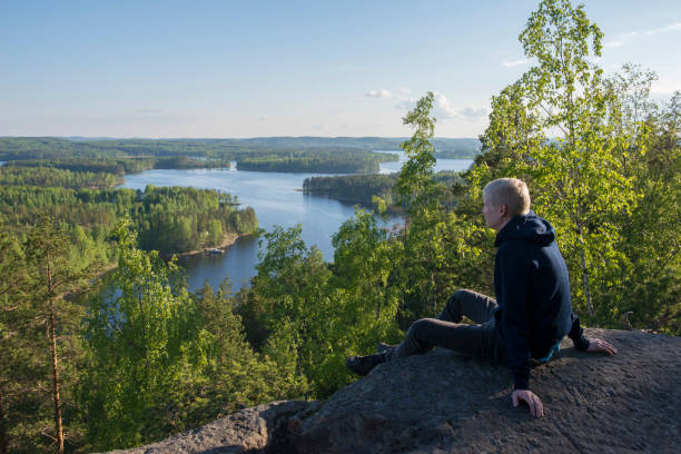Man sitting in national park Boy sitting in national park Neitvuori in Mikkeli region, Finland saimaa stock pictures, royalty-free photos & images