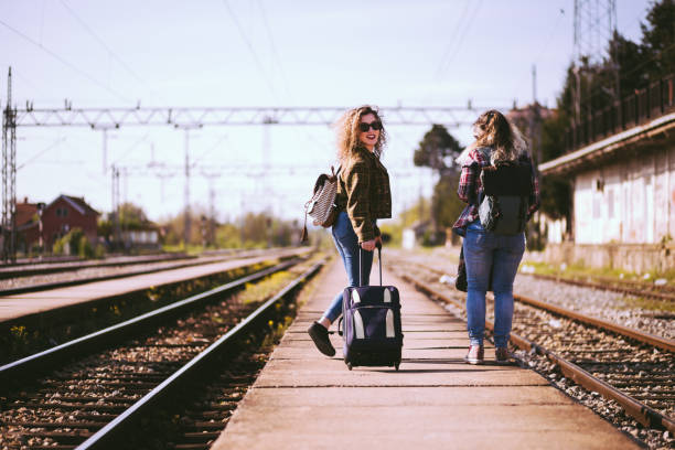 istock Traveler Girlfriends, Walking On Railroad Station 695075488