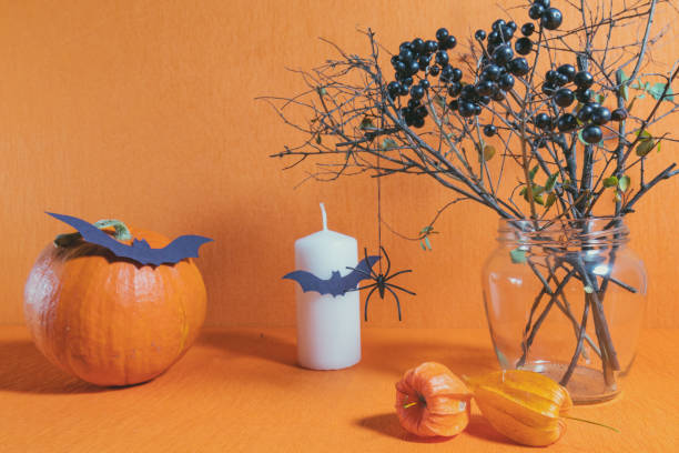 istock Halloween home decorations on orange background 695075684