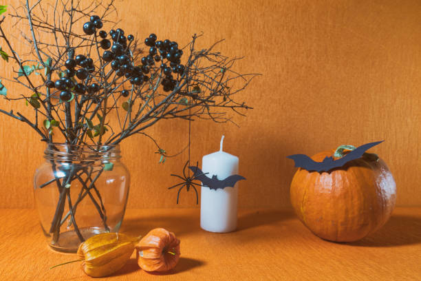 istock Halloween home decorations on orange background 695075686