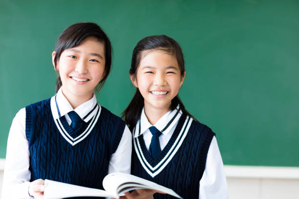 smiling  teenager student girls in  classroom - chinese ethnicity student china asian ethnicity imagens e fotografias de stock