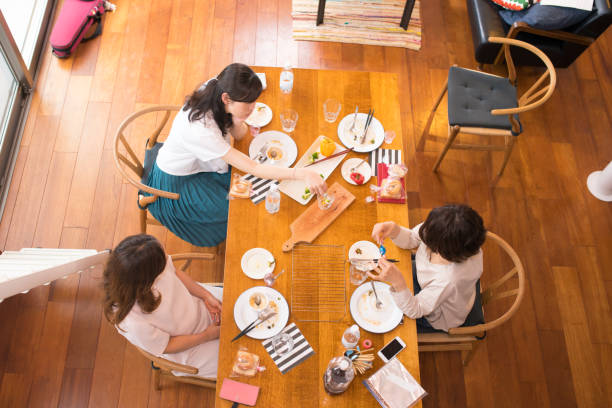 istock Female friends having lunch and chat at home 695093864