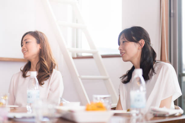 istock Female friends having lunch and chat at home 695093942