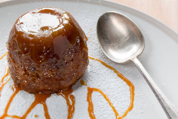 istock Sticky Toffee Pudding With Caramel Sauce and a Spoon 695097006