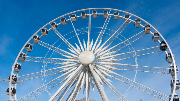 istock Ferris wheel rotating on blue sky background. 695101970