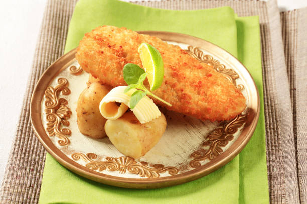 istock Fried fish fillet with new potatoes 695103642