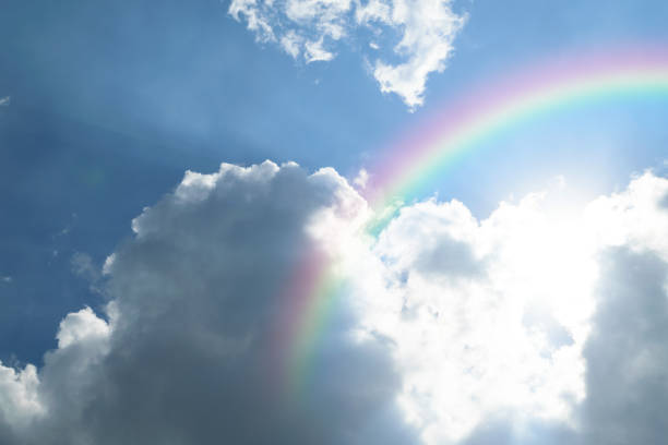 Nature cloudscape with blue sky and white cloud with rainbow stock photo