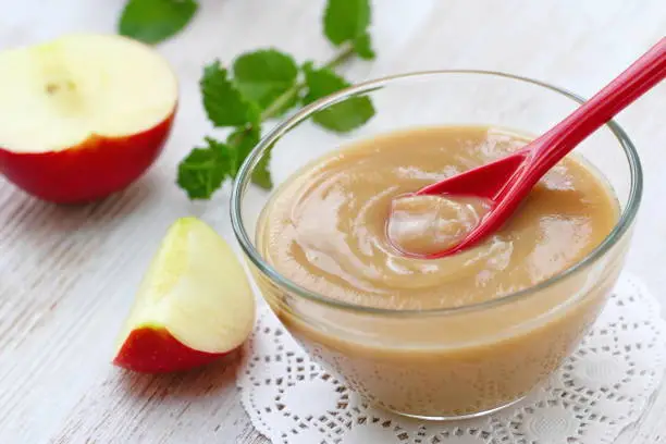 Baby food. Apple puree and fresh apples
