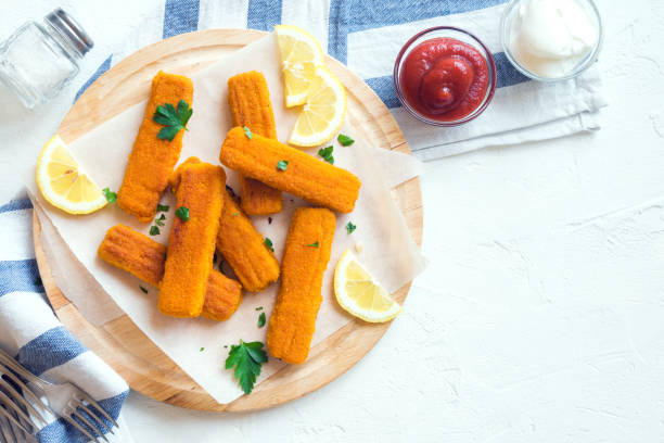 Fried Fish Sticks Fried Fish Sticks. Fish Fingers. Fish Sticks with lemon and sauces ready to eat. fish stick stock pictures, royalty-free photos & images