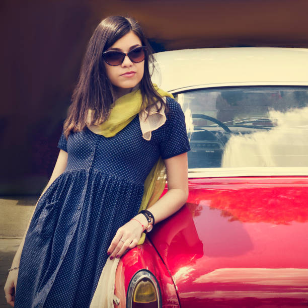 istock Beautiful young lady near a retro car. 695111948
