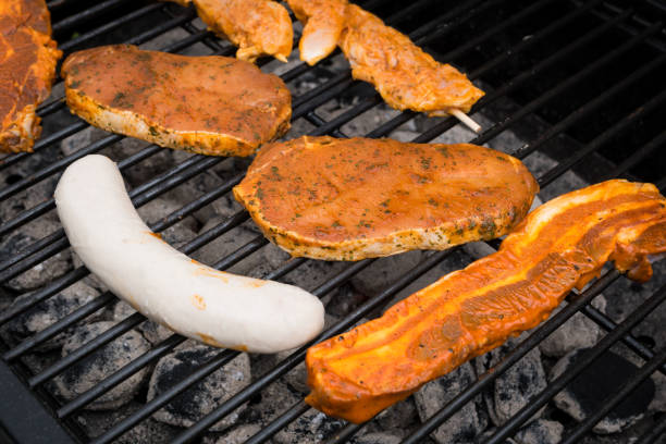 istock Grilling sausages and fresh steaks on barbecue grill 695116610