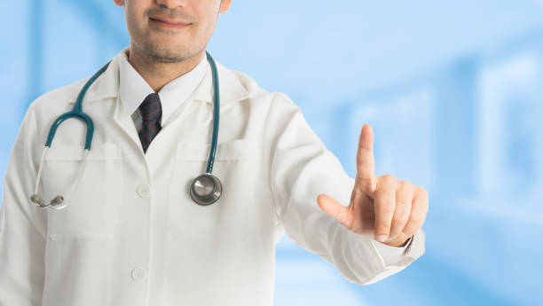 istock Male doctor pointing finger at copy space. 695120612