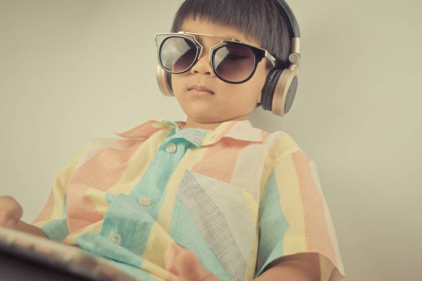 istock boy is watching movie on headphone and tablet 695122936