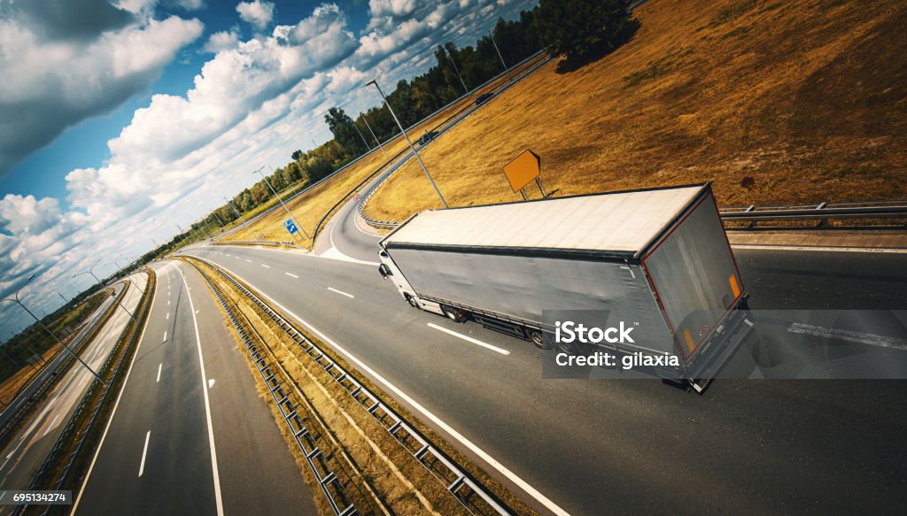 Heavy Cargo on the Road Closeup top view of a white tanker truck keeping delivering goods on a highway. Toned shot, logo and brand free Truck Stock Photo