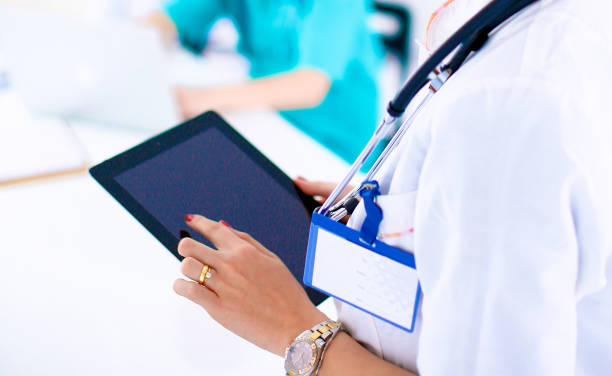 istock Young woman  doctor holding a tablet p 695134620