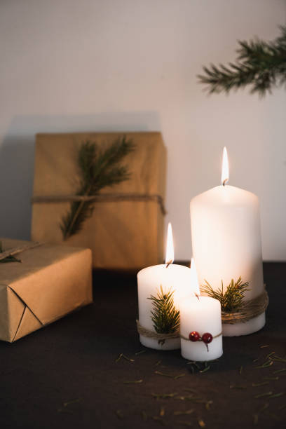 istock Christmas decorations on tha table, lit candles and gifts 695134924