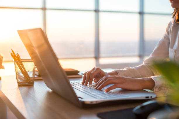 female teleworker texting using laptop and internet, working online. freelancer typing at home office, workplace. - keyboard computer hands imagens e fotografias de stock