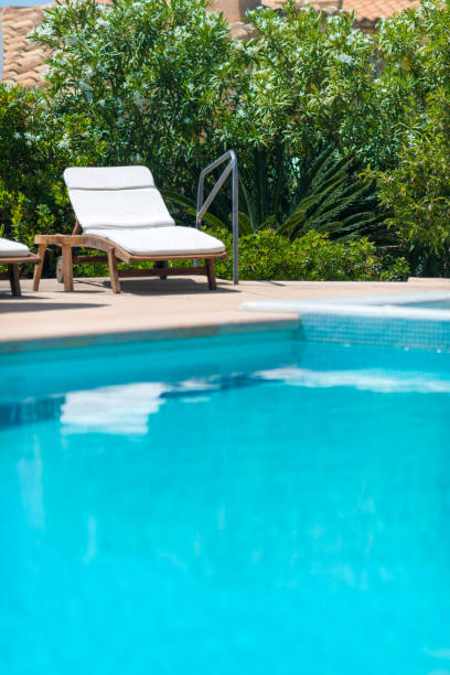 istock beach chair on pool with turquoise water 695137166