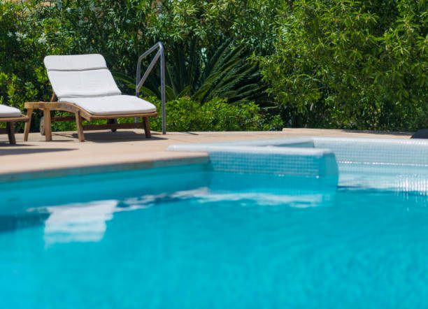 istock beach chair on pool with turquoise water 695137308