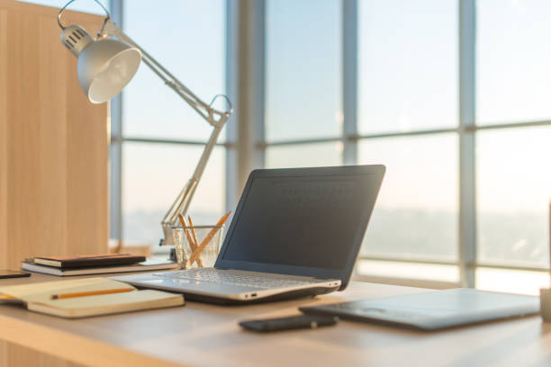 istock Side view picture of studio workplace with blank notebook, laptop. Comfortable work table, home office. 695137644