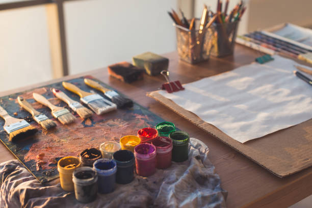 istock Painter workplace. Palette with brushstrokes and paintbrushes. Colorful gouache, crayons sets 695137804