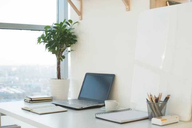 istock Side view picture of studio workplace with blank notebook, laptop. Designer comfortable work table, home office. 695141228