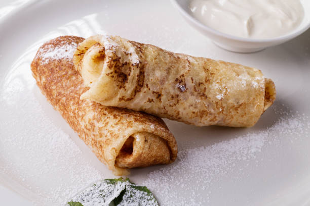 istock russian pancake folded on a white plate on the dark background 695144060