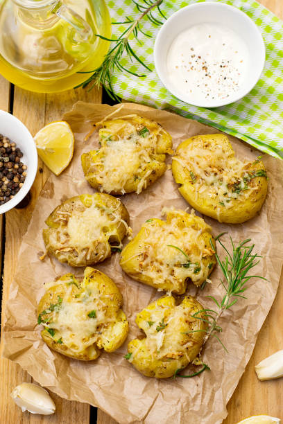 istock Crash hot potatoes with garlic, cheese and rosemary 695144654