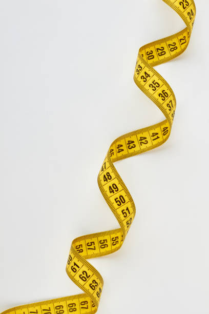 istock Yellow swirly measuring tape. 695158512