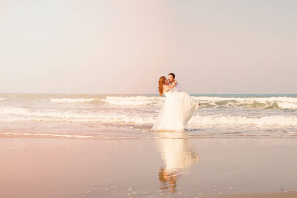 istock Bride and groom at beach 695161030
