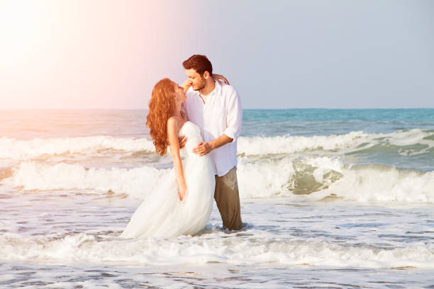 istock Bride and groom at beach 695161594