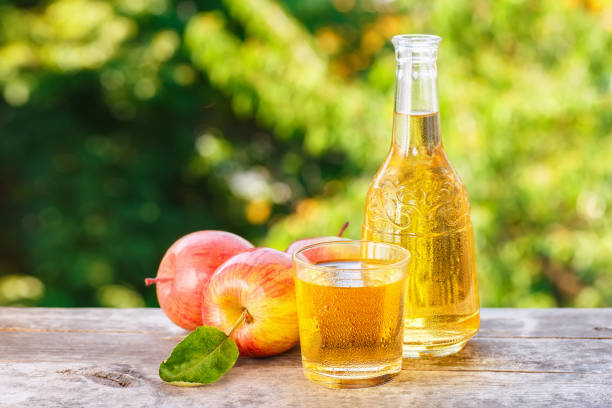 istock apple cider or juice on natural background 695164736